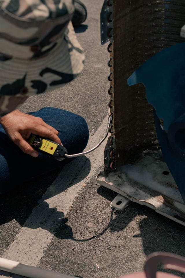 Technician diagnosing heating and cooling equipment
